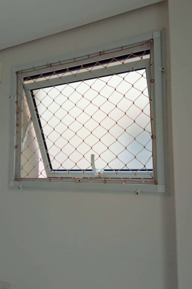 Janela de banheiro protegida para evitar fuga de pets em casas e apartamentos